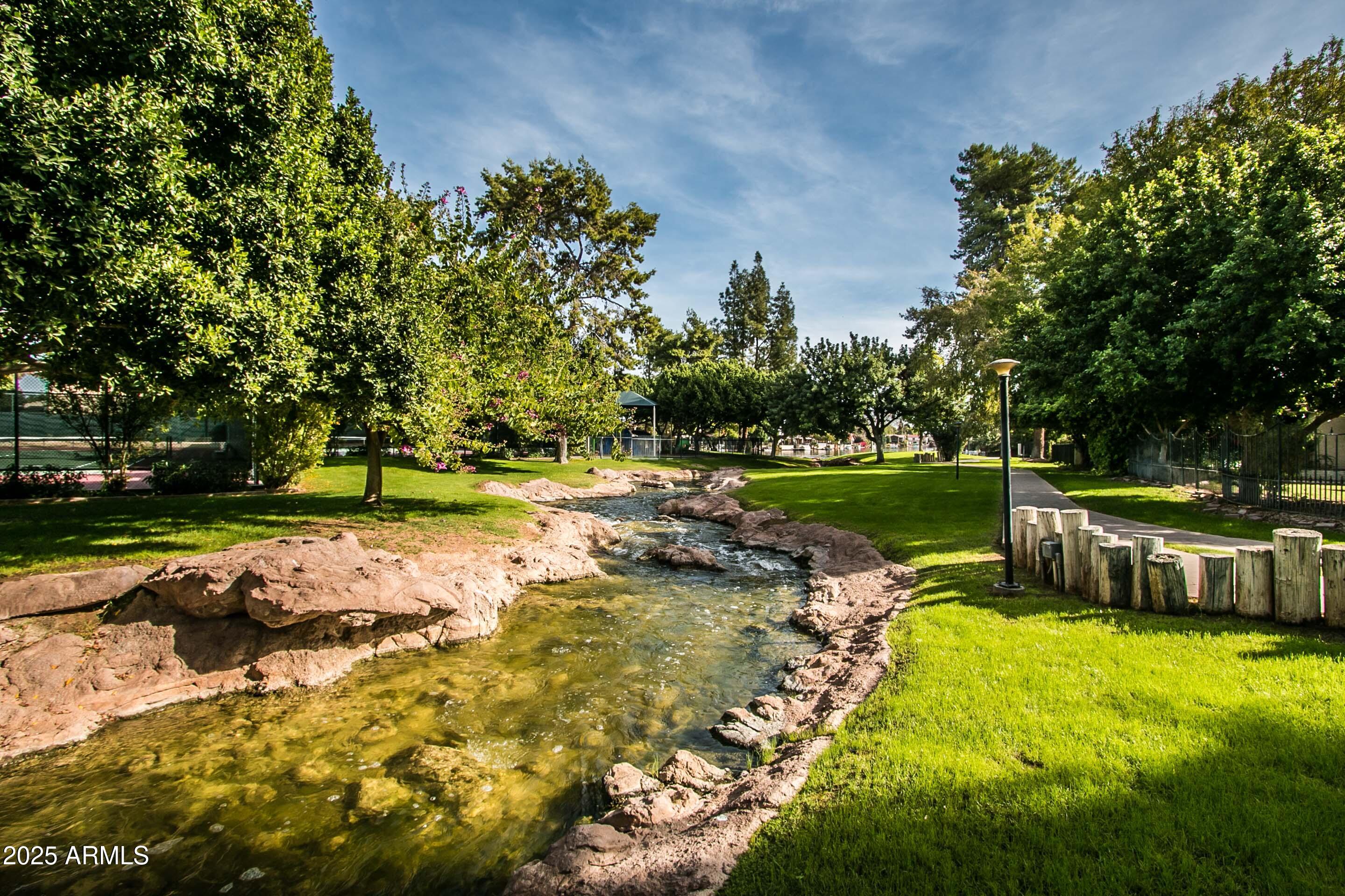 5627 South Crows Nest Road Tempe, AZ 85283 - Photo 84 of 93 a view of a swimming pool with a patio and a yard