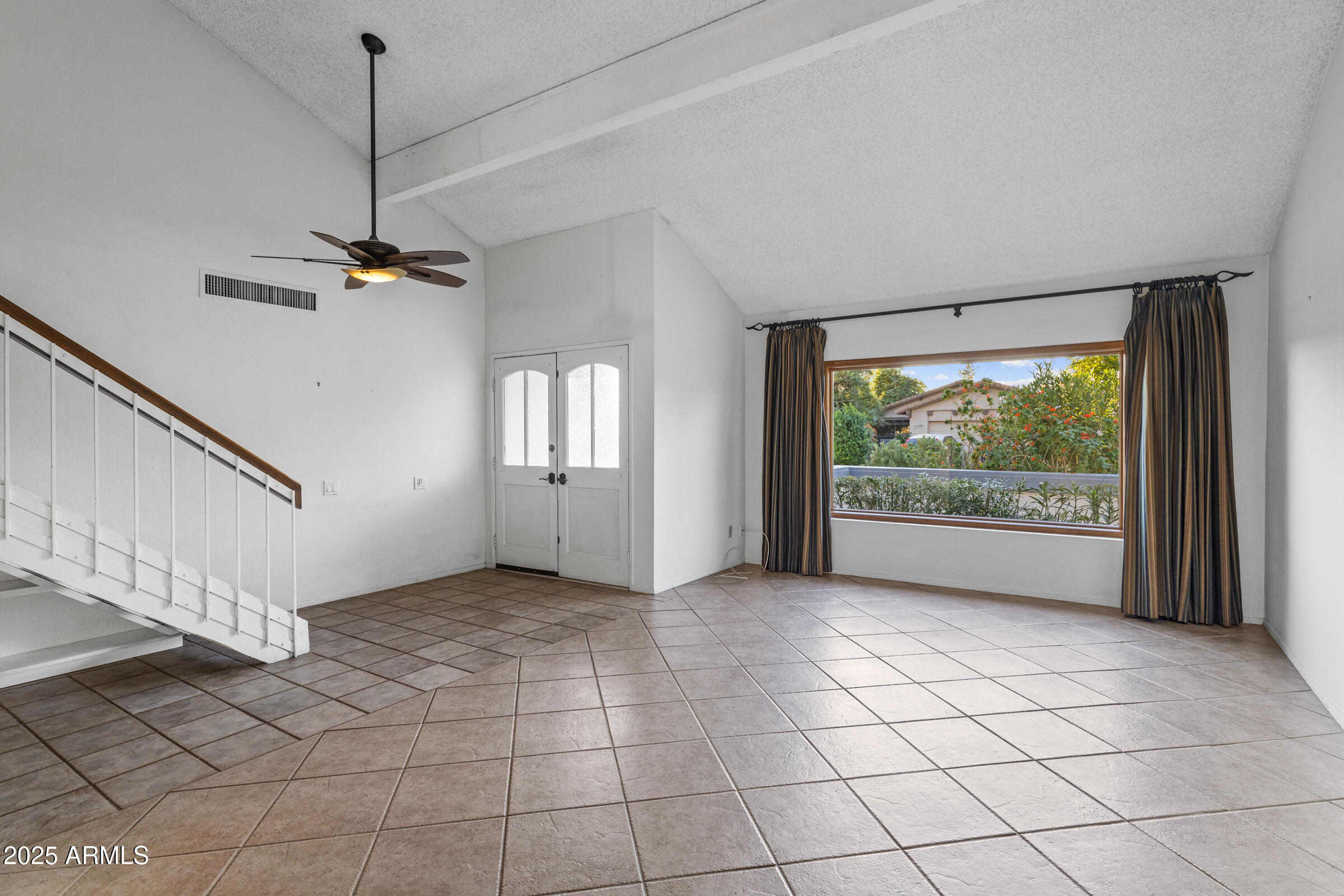 5627 South Crows Nest Road Tempe, AZ 85283 - Photo 9 of 93 a view of a livingroom with a ceiling fan and window