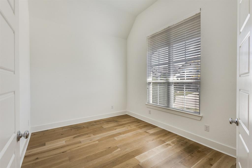 1704 Hydrangea Lane Prosper, TX 75078 - Photo 12 of 25 Empty room featuring light wood finished floors and lofted ceiling