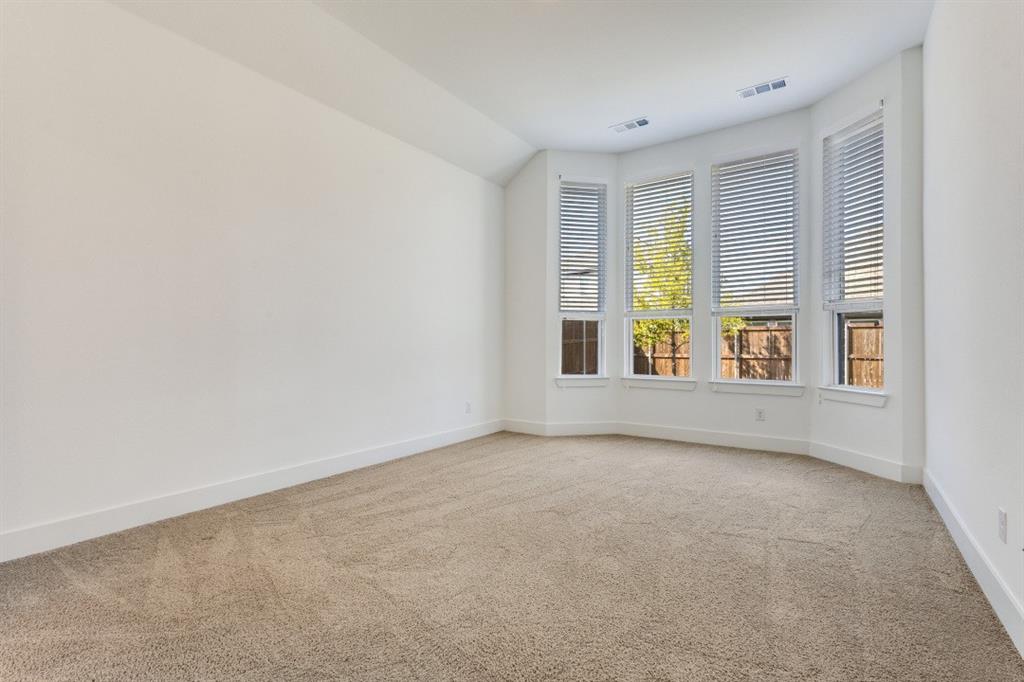 1704 Hydrangea Lane Prosper, TX 75078 - Photo 20 of 25 Unfurnished room featuring light carpet and lofted ceiling
