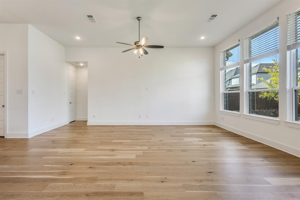 1704 Hydrangea Lane Prosper, TX 75078 - Photo 3 of 25 Spare room with light wood-style floors, recessed lighting, and ceiling fan
