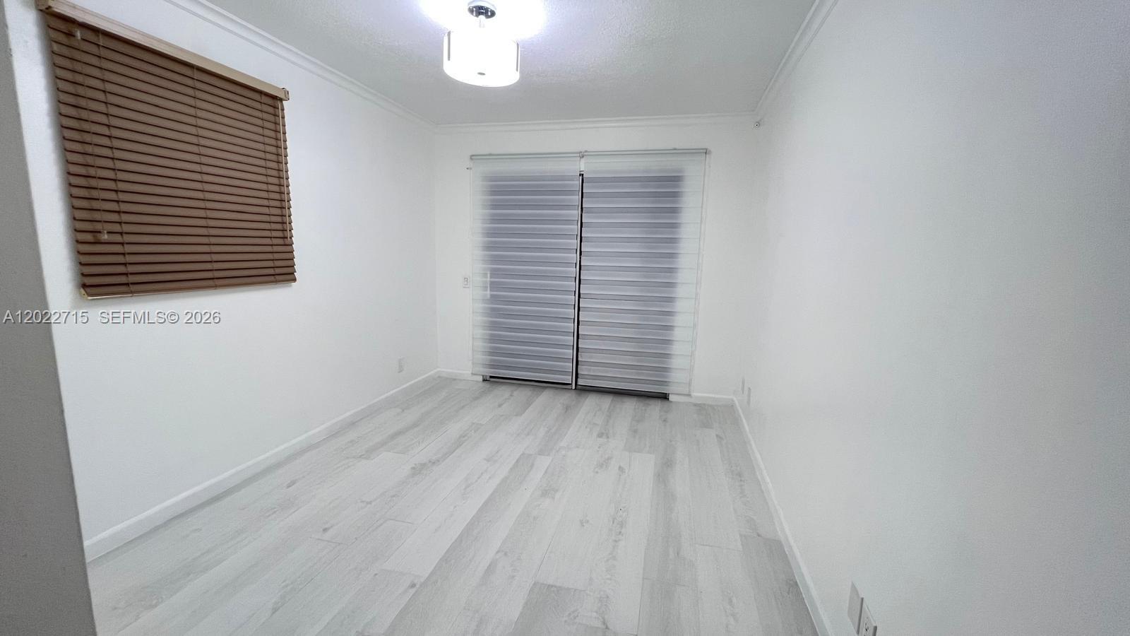 10669 Boca Entrada Boulevard Boca Raton, FL 33428 - Photo 15 of 19 a view of room with window and hardwood floor
