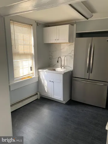a kitchen with stainless steel appliances a refrigerator sink and cabinets
