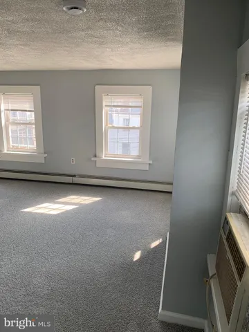 an empty room with a fireplace