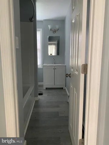 a view of entryway with wooden floor and front door