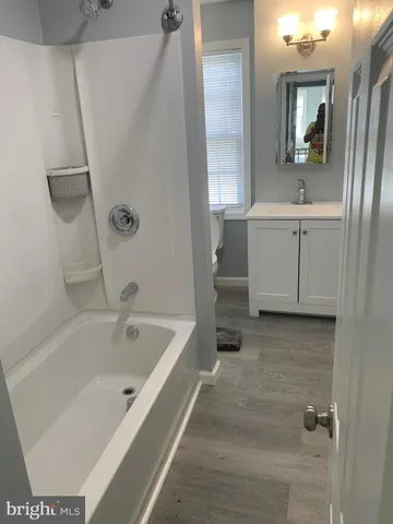 a bathroom with a bathtub and a sink