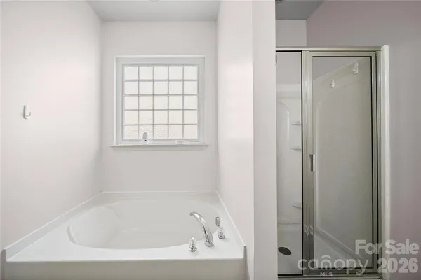a white bath tub sitting next to a window