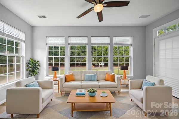 a living room with furniture and a large window