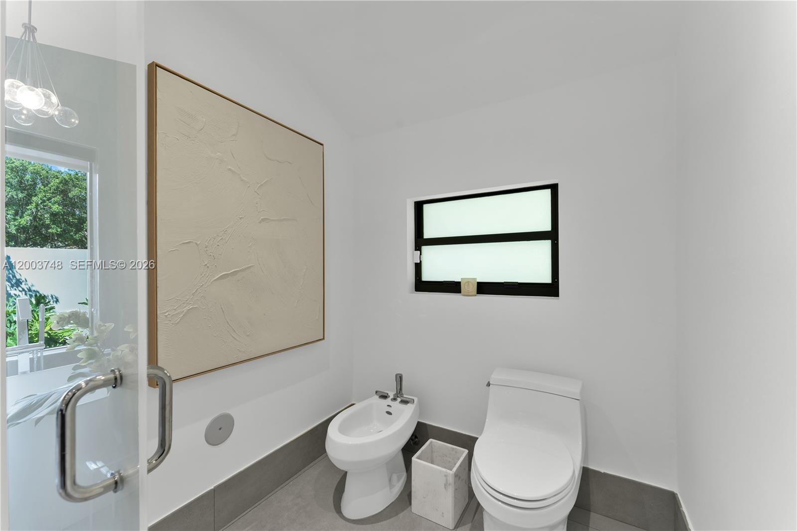 2675 Hackney Road Weston, FL 33331 - Photo 47 of 61 a white toilet sitting next to a bathroom sink
