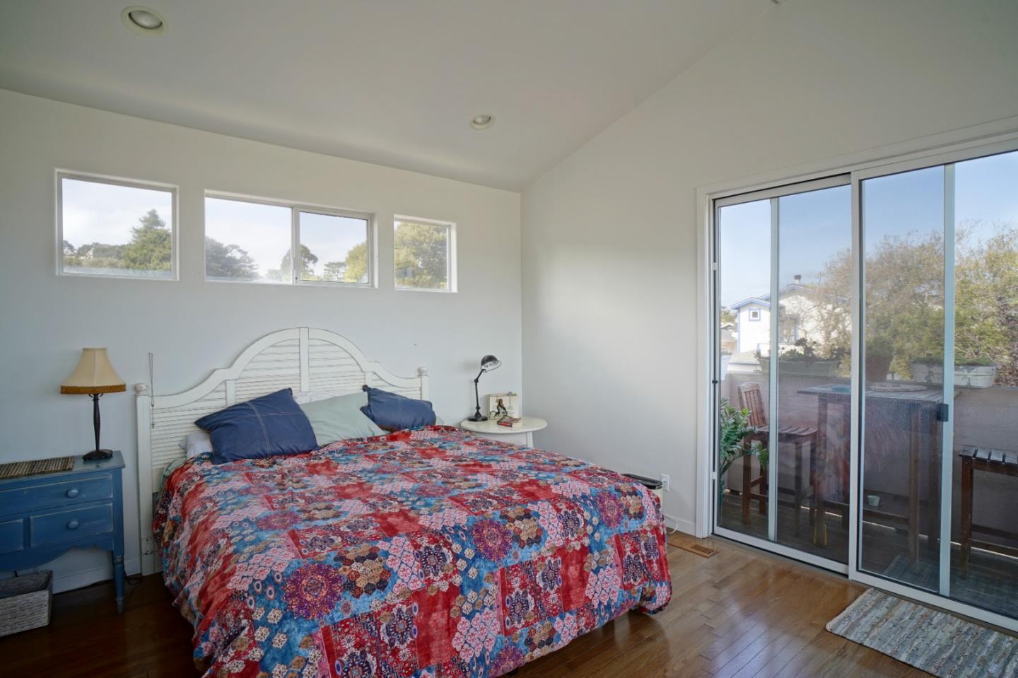 928 Hellam Street Monterey, CA 93940 - Photo 18 of 25 a bedroom with a large bed and a wooden floor