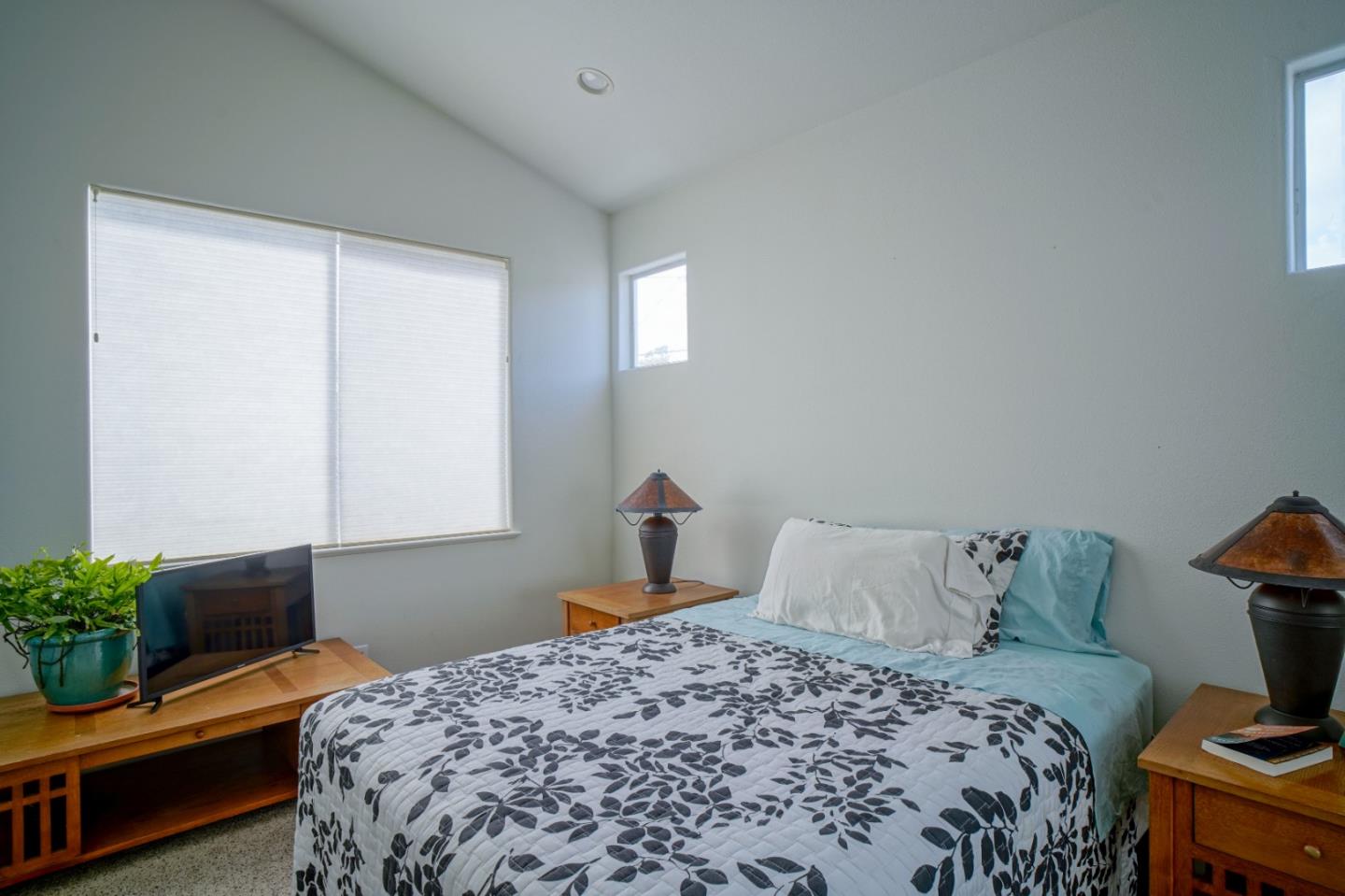 928 Hellam Street Monterey, CA 93940 - Photo 20 of 25 a bedroom with a bed and a potted plant