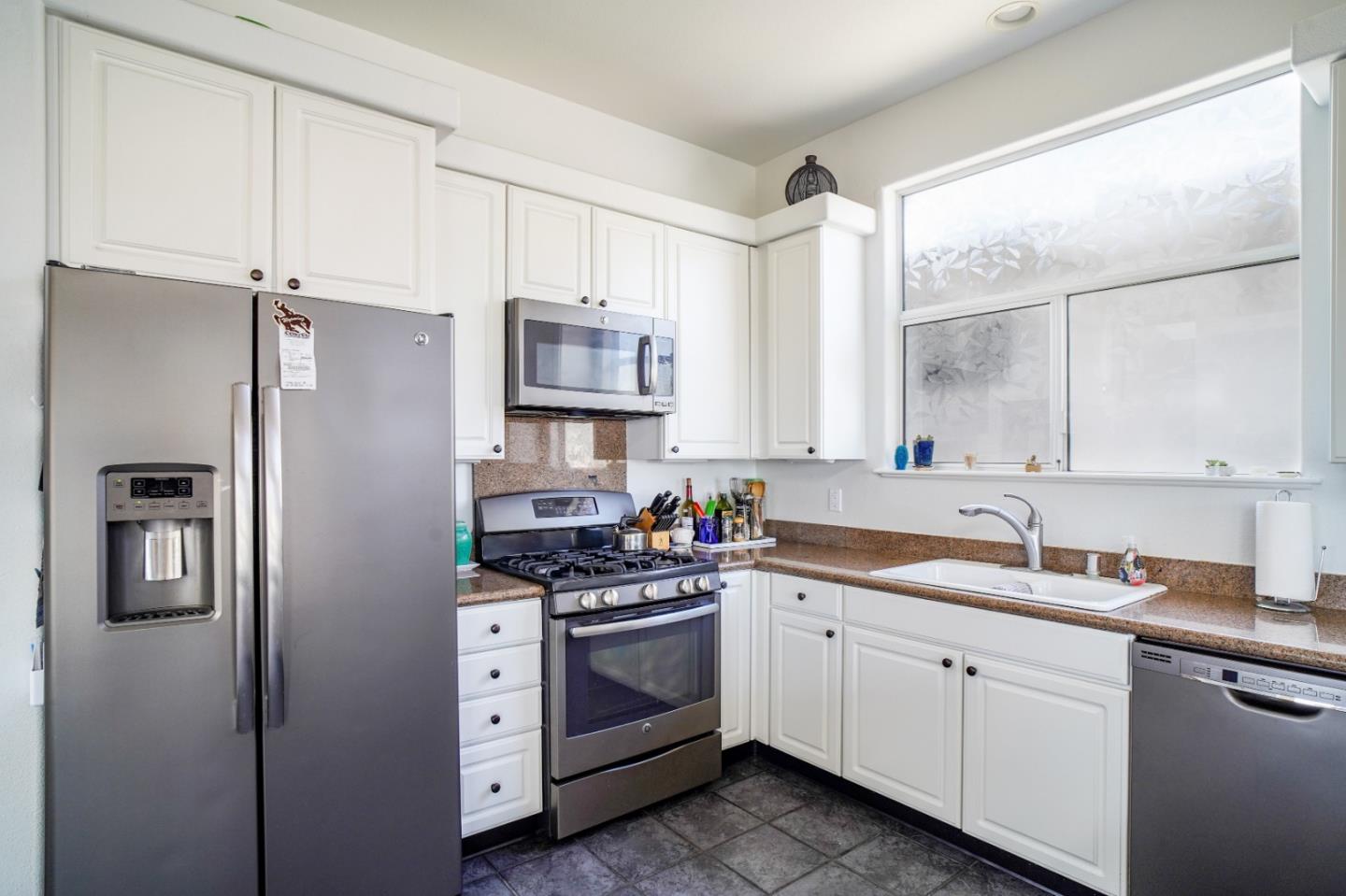928 Hellam Street Monterey, CA 93940 - Photo 6 of 25 a kitchen with white cabinets and white appliances