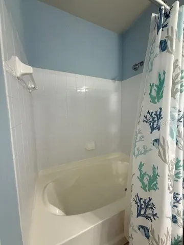 a bathroom with a bathtub and shower