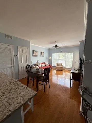 a dining room with furniture and wooden floor