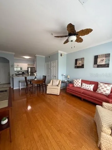 a living room with furniture and kitchen view