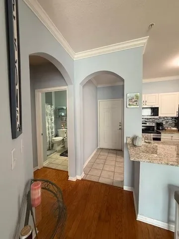 a living room with a bed and next to a window