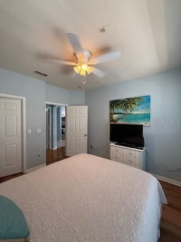 a bedroom with a bed and a chandelier