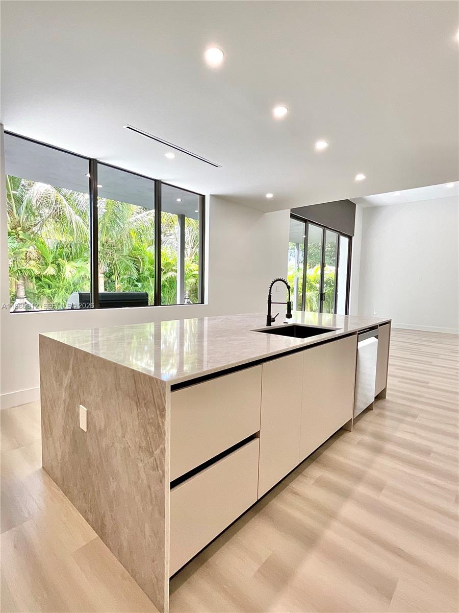 536 Northwest 48th Street Miami, FL 33127 - Photo 1 of 40 a kitchen with kitchen island and a large window