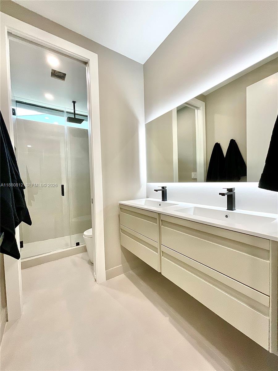 536 Northwest 48th Street Miami, FL 33127 - Photo 11 of 40 a bathroom with a tub sink and mirror