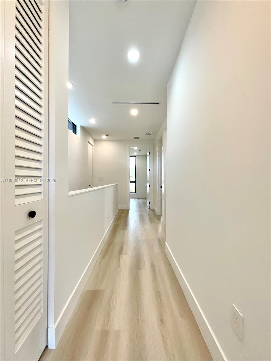 536 Northwest 48th Street Miami, FL 33127 - Photo 13 of 40 a view of a hallway with wooden floor