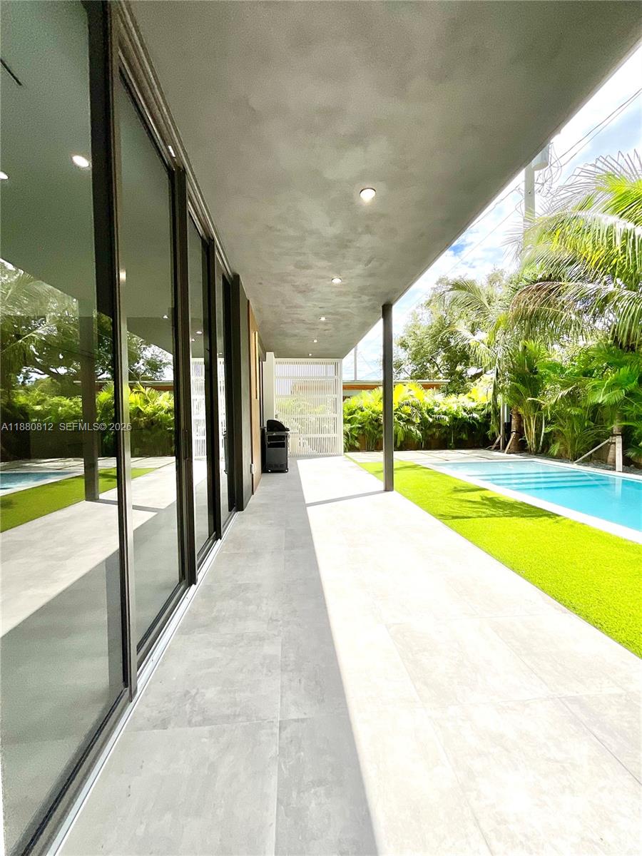 536 Northwest 48th Street Miami, FL 33127 - Photo 27 of 40 a view of swimming pool with a garden and patio