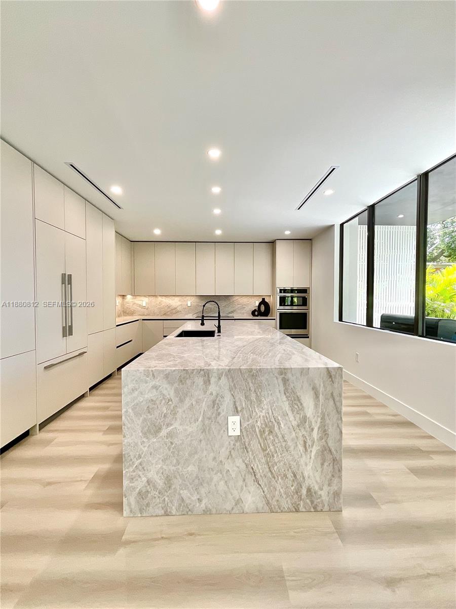 536 Northwest 48th Street Miami, FL 33127 - Photo 3 of 40 a view of kitchen with stainless steel appliances kitchen island sink and living room
