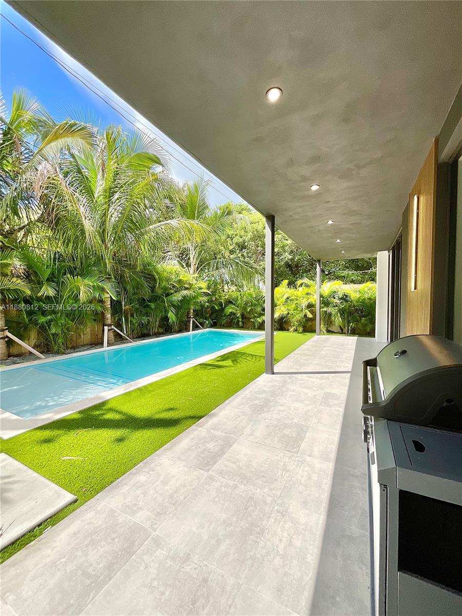 536 Northwest 48th Street Miami, FL 33127 - Photo 31 of 40 a view of a swimming pool with a yard