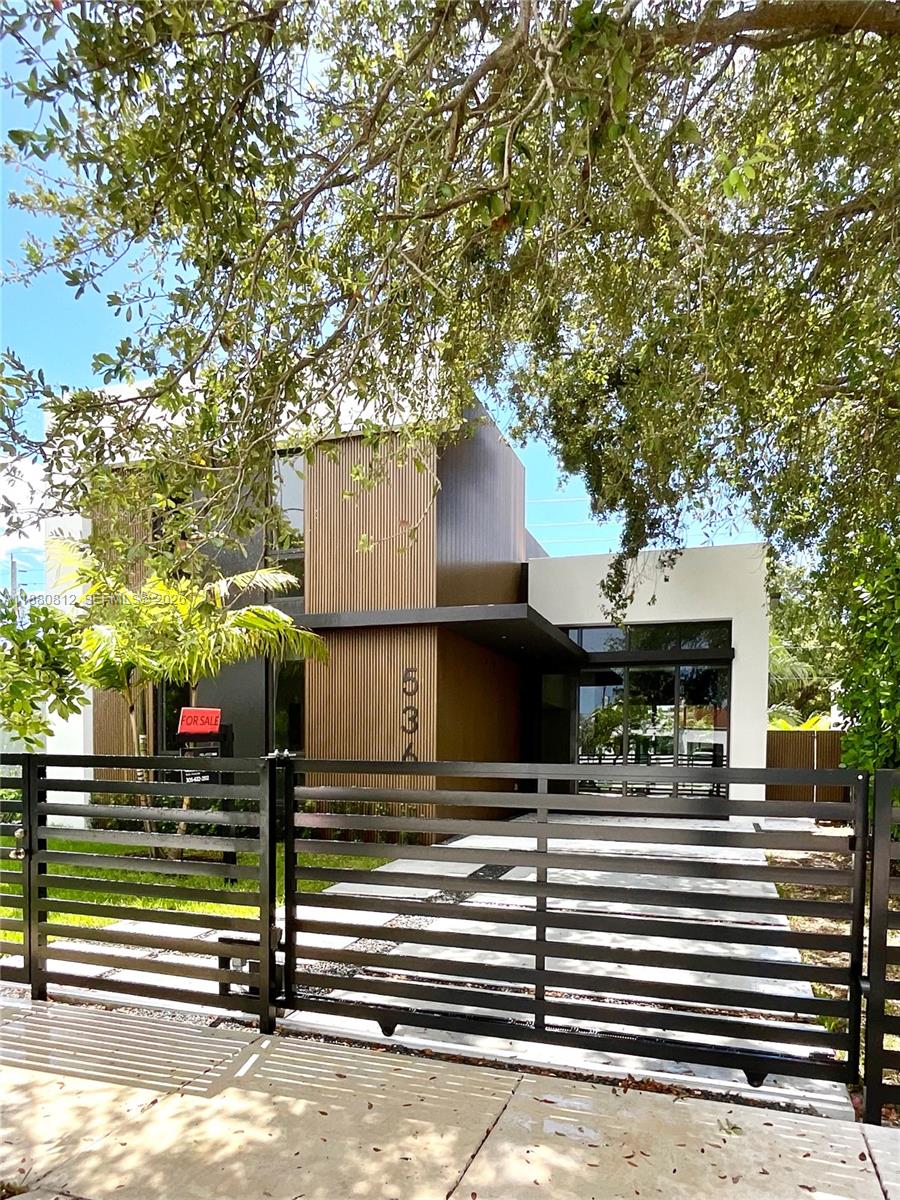 536 Northwest 48th Street Miami, FL 33127 - Photo 33 of 40 a view of a house with a large tree