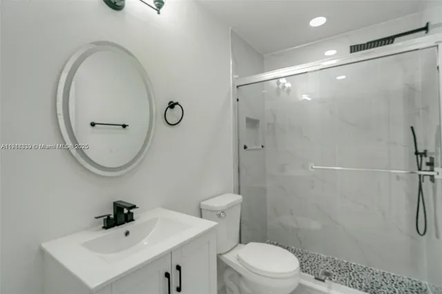 a bathroom with a toilet a sink and shower