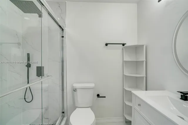 a bathroom with a toilet sink and shower