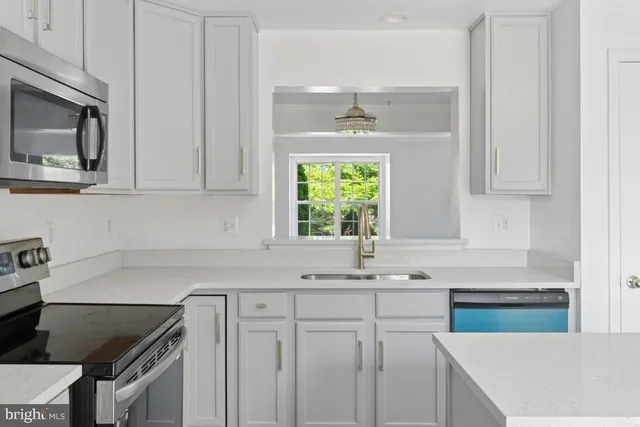 a kitchen with stainless steel appliances cabinets a window and a sink