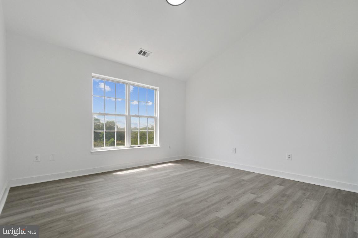 1109 Pomelo Court, Unit 1109 Baltimore, MD 21228 - Photo 14 of 40 wooden floor in an empty room with a window