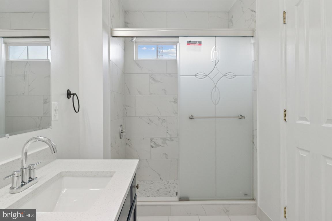 1109 Pomelo Court, Unit 1109 Baltimore, MD 21228 - Photo 21 of 40 a bathroom with a sink and a shower