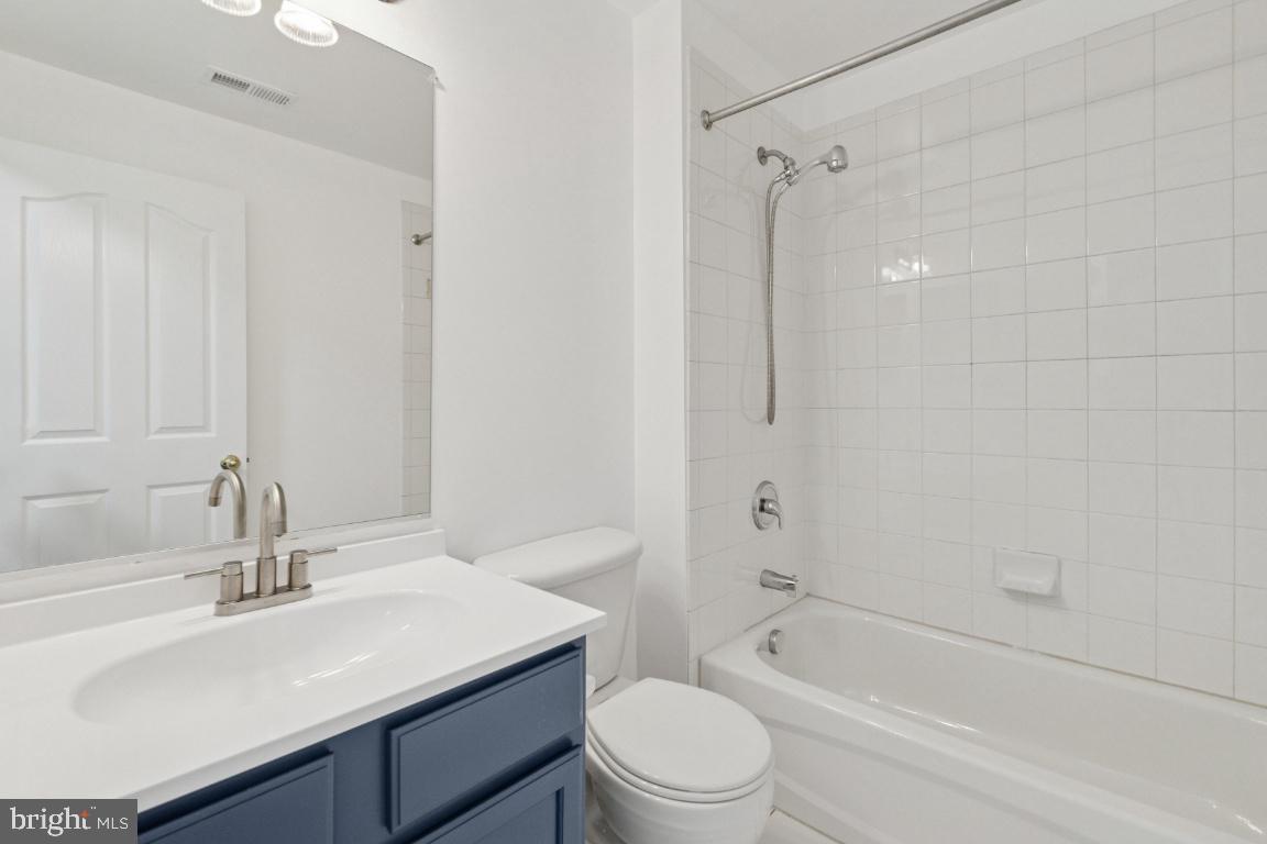 1109 Pomelo Court, Unit 1109 Baltimore, MD 21228 - Photo 31 of 40 a bathroom with a sink toilet vanity and shower