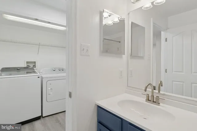 a bathroom with a sink vanity and a mirror