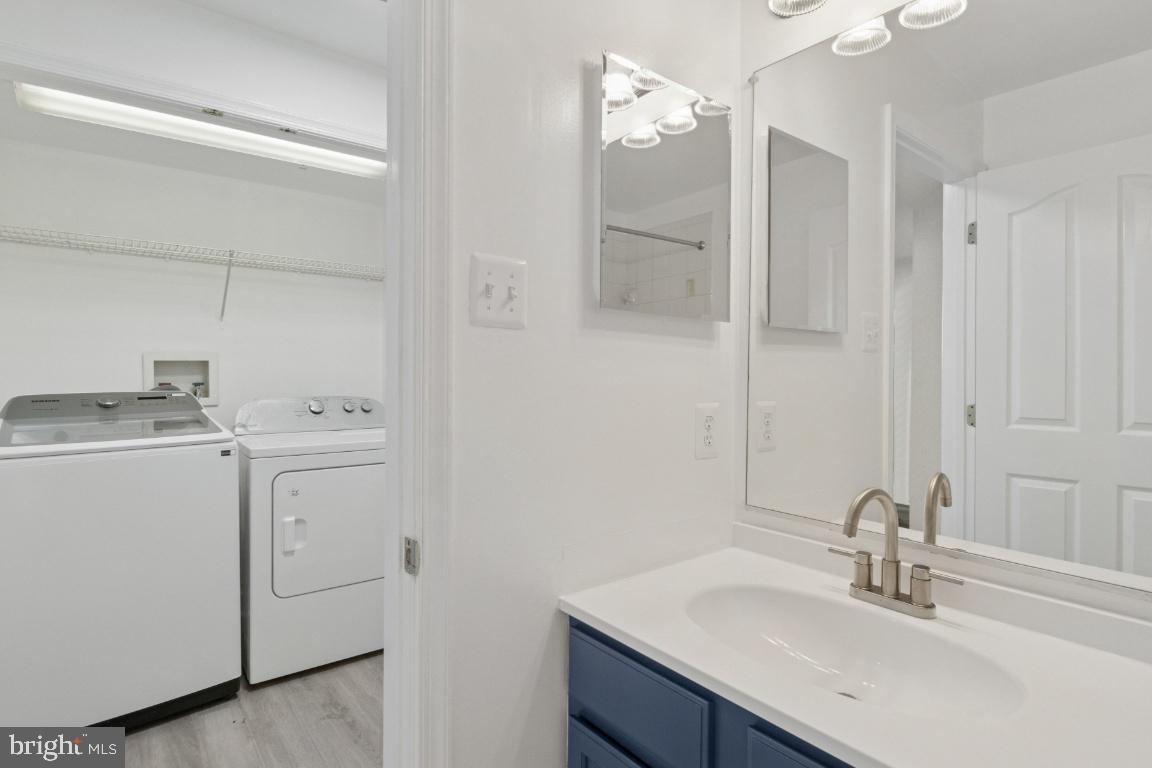1109 Pomelo Court, Unit 1109 Baltimore, MD 21228 - Photo 32 of 40 a bathroom with a sink vanity and a mirror