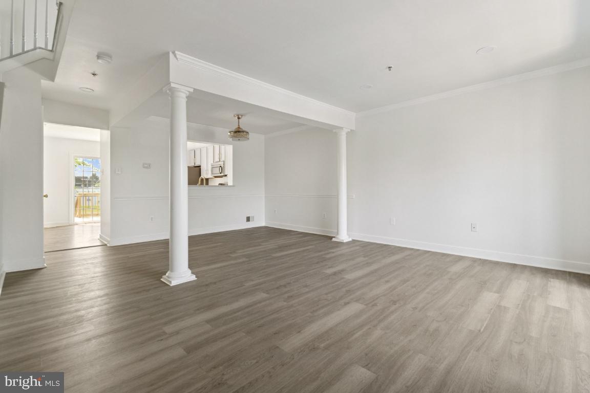 1109 Pomelo Court, Unit 1109 Baltimore, MD 21228 - Photo 4 of 40 an empty room with wooden floor & windows