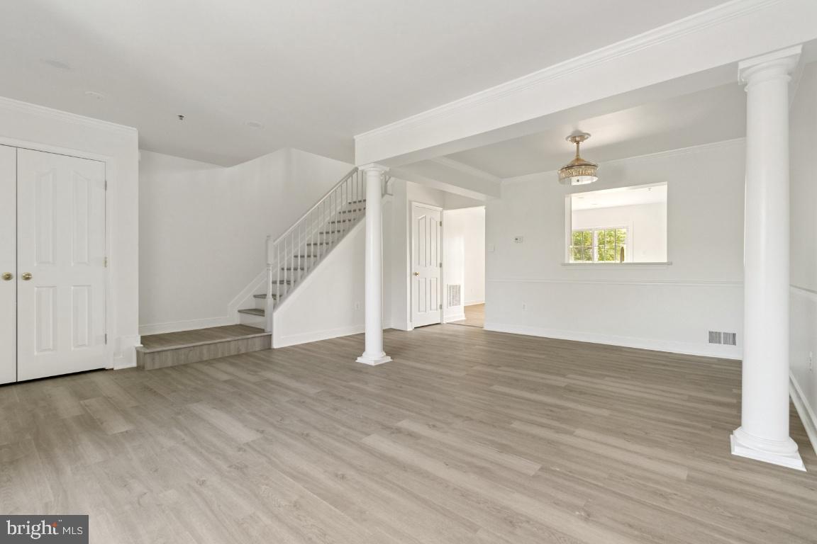 1109 Pomelo Court, Unit 1109 Baltimore, MD 21228 - Photo 5 of 40 an empty room with wooden floor and windows