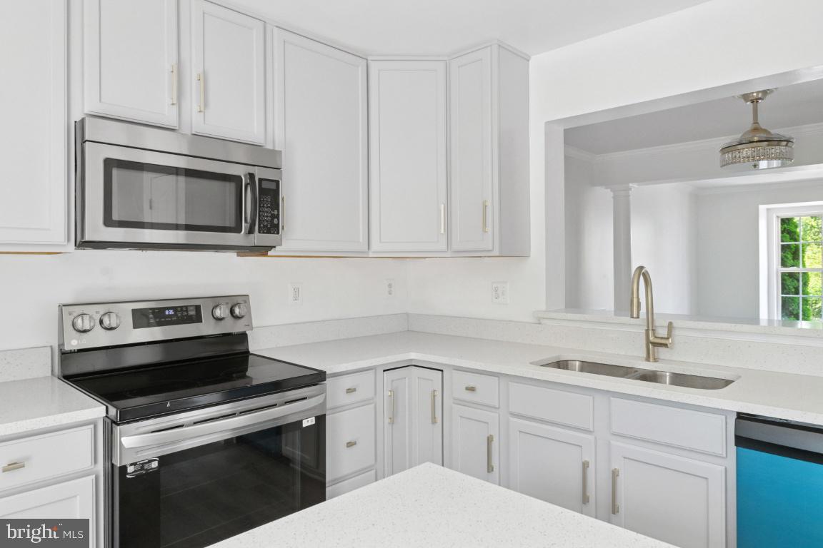 1109 Pomelo Court, Unit 1109 Baltimore, MD 21228 - Photo 9 of 40 a kitchen with cabinets stainless steel appliances and sink
