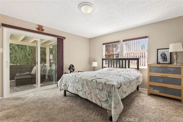 a bed sitting in a bedroom next to a window