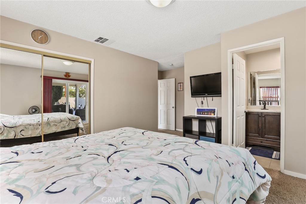 19709 Strathern Street Winnetka, CA 91306 - Photo 15 of 31 a bedroom with a bed and a flat screen tv