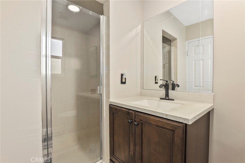 19709 Strathern Street Winnetka, CA 91306 - Photo 16 of 31 a bathroom with a sink and a mirror