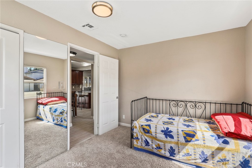 19709 Strathern Street Winnetka, CA 91306 - Photo 18 of 31 a bedroom with a bed and a couch