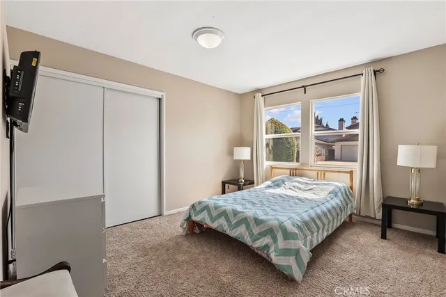 a bedroom with a large bed and a window