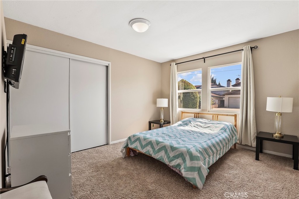 19709 Strathern Street Winnetka, CA 91306 - Photo 19 of 31 a bedroom with a large bed and a window