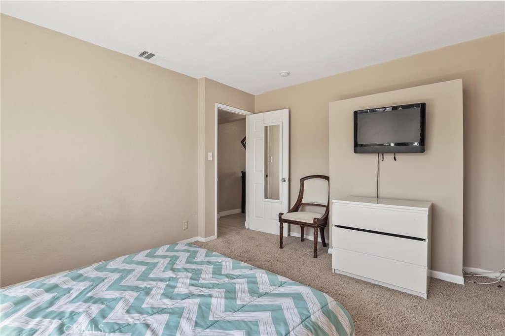 19709 Strathern Street Winnetka, CA 91306 - Photo 20 of 31 a bedroom with a bed and a flat screen tv