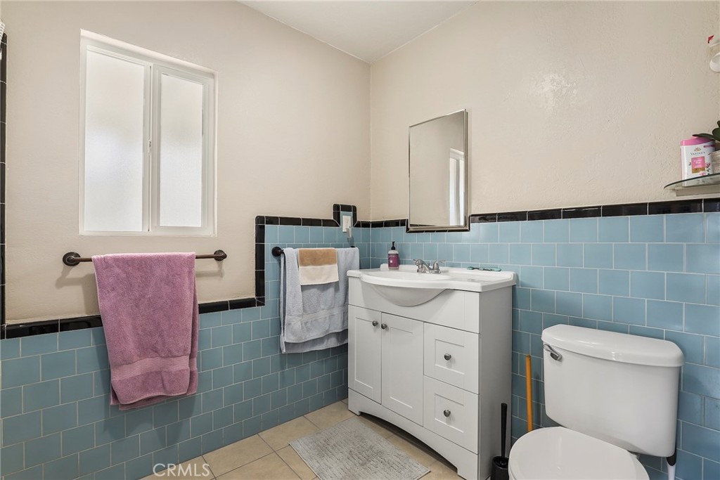 19709 Strathern Street Winnetka, CA 91306 - Photo 21 of 31 a bathroom with a sink toilet and mirror