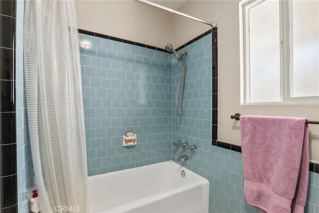 a bathroom with a bathtub and shower