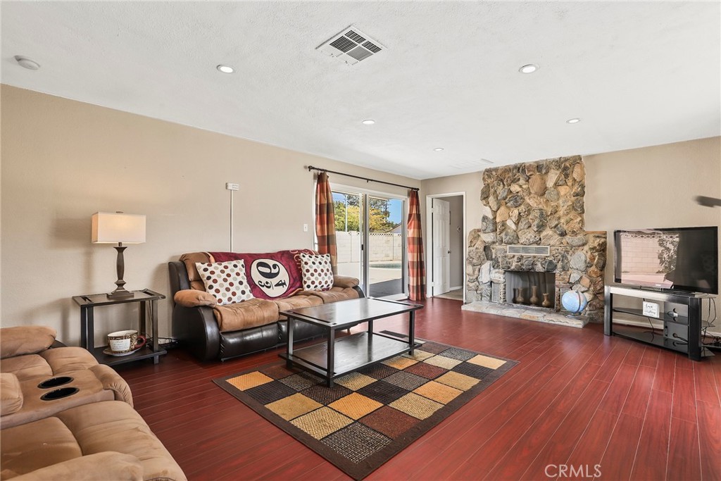 19709 Strathern Street Winnetka, CA 91306 - Photo 6 of 31 a living room with furniture a flat screen tv and a fireplace