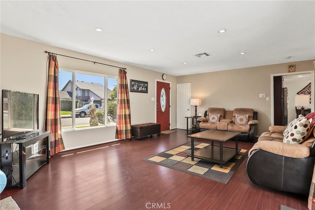 19709 Strathern Street Winnetka, CA 91306 - Photo 8 of 31 a living room with furniture and a flat screen tv with wooden floor